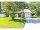 Charming front exterior of home with brick accents, mature trees, and a driveway at 9664 Middleton Ct., Murrells Inlet, SC 29576