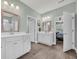 Bright bathroom features double vanities and mirrors; bathroom leads to walk-in shower and bedroom at 1009 Oak Marsh Ln., North Myrtle Beach, SC 29582