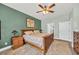 Cozy bedroom with wood-frame bed, ceiling fan, and neutral tones; a restful retreat at 1009 Oak Marsh Ln., North Myrtle Beach, SC 29582