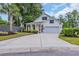 Charming single Gathering home featuring a well-manicured lawn, attached garage, and eye-catching red front door at 1009 Oak Marsh Ln., North Myrtle Beach, SC 29582