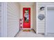 Charming front entrance with a vibrant red door, a welcoming mat and stylish decor at 1009 Oak Marsh Ln., North Myrtle Beach, SC 29582