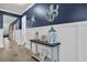 Charming hallway with coastal decor, neutral paint, white wainscotting and light wood floors at 1009 Oak Marsh Ln., North Myrtle Beach, SC 29582