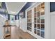 Elegant hallway featuring French doors leading to a home office, and stylish décor at 1009 Oak Marsh Ln., North Myrtle Beach, SC 29582