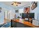 Cozy office space with blue walls, ceiling fan and large monitor on wood desk at 1009 Oak Marsh Ln., North Myrtle Beach, SC 29582
