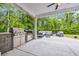 Inviting outdoor patio with built-in stainless steel grill, outdoor kitchen, and comfortable seating at 1009 Oak Marsh Ln., North Myrtle Beach, SC 29582