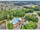 Overhead view of a community pool and play area bordered by mature trees, near residential streets at 1065 Harvester Circle, Myrtle Beach, SC 29579
