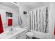 Clean bathroom features a tub, shower with decorative curtain, a sink, and a modern vanity for a fresh and updated feel at 1065 Harvester Circle, Myrtle Beach, SC 29579