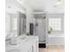 Bright bathroom featuring double sinks, soaking tub, and a walk-in shower, combining luxury with practical design elements at 1065 Harvester Circle, Myrtle Beach, SC 29579
