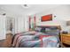 Bedroom with warm, natural light, a unique accent wall art piece and well-placed nightstands for a relaxing ambiance at 1065 Harvester Circle, Myrtle Beach, SC 29579