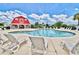 Resort-style pool area with ample seating and a charming red barn-style building enhancing community living at 1065 Harvester Circle, Myrtle Beach, SC 29579