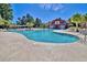 Community pool featuring ample lounge chairs, nearby palm trees and a clear blue sky at 1065 Harvester Circle, Myrtle Beach, SC 29579