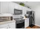 Modern kitchen featuring black appliances, white cabinets, and granite countertops at 1065 Harvester Circle, Myrtle Beach, SC 29579
