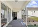 View of the screened porch featuring durable carpet and a conveniently located refrigerator, offering extra storage at 1065 Harvester Circle, Myrtle Beach, SC 29579