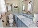 Cozy bathroom features marble countertops, a standard toilet, and mirrored vanity at 1104 Ragin St., Myrtle Beach, SC 29577