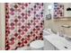A modest bathroom with a toilet, vanity, mirror, polka dot shower curtain, and a vintage-inspired style at 1104 Ragin St., Myrtle Beach, SC 29577