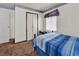 A quaint bedroom featuring a blue striped bedspread and neutral walls with vintage wallpaper border at 1104 Ragin St., Myrtle Beach, SC 29577
