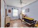 Bedroom with bright blue walls, wood floors and a large window providing natural light at 1104 Ragin St., Myrtle Beach, SC 29577