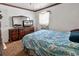 Bedroom with blue comforter, vintage dresser with mirror and window AC unit at 1104 Ragin St., Myrtle Beach, SC 29577