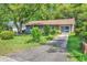Single-story brick home has a well-kept lawn and mature trees at 1104 Ragin St., Myrtle Beach, SC 29577