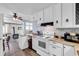 Well-lit kitchen features white cabinets, ample counter space, and a view into the adjacent living area at 1104 Ragin St., Myrtle Beach, SC 29577