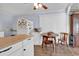 Cozy kitchen with white cabinetry and appliances, plus an adjacent dining area with a wooden table at 1104 Ragin St., Myrtle Beach, SC 29577