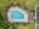 Aerial view of a community pool with lounge chairs and tables at 112 Olde Towne Way # 5, Myrtle Beach, SC 29588