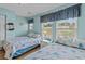 Bright bedroom with two beds, ceiling fan, and light blue walls exudes coastal charm at 112 Olde Towne Way # 5, Myrtle Beach, SC 29588