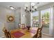 Bright dining room features a classic chandelier, large windows, and seating for four at 112 Olde Towne Way # 5, Myrtle Beach, SC 29588