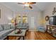 Cozy living room featuring hardwood floors, a comfortable sofa, and access to the patio at 112 Olde Towne Way # 5, Myrtle Beach, SC 29588