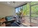 Inviting screened-in porch with comfortable seating and a view of lush greenery at 112 Olde Towne Way # 5, Myrtle Beach, SC 29588