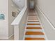 Wooden staircase with white railings leads to the upper level at 112 Olde Towne Way # 5, Myrtle Beach, SC 29588