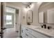 Bathroom with double sinks, white cabinets, granite countertops, and modern hardware at 1142 Fiddlehead Way, Myrtle Beach, SC 29579