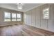 Bright bedroom with decorative trim, large windows offering scenic views, and hardwood flooring at 1142 Fiddlehead Way, Myrtle Beach, SC 29579