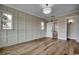 Bedroom with custom wall details, hardwood floors, a contemporary ceiling light, and access to the bathroom at 1142 Fiddlehead Way, Myrtle Beach, SC 29579