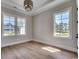 Bedroom featuring hardwood floors, natural light from a bright window, and neutral paint at 1142 Fiddlehead Way, Myrtle Beach, SC 29579