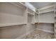 Walk-in closet featuring custom built in shelving with chrome rods and neutral color scheme at 1142 Fiddlehead Way, Myrtle Beach, SC 29579
