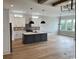 Open kitchen with an island, hardwood floors, modern cabinets, and stainless steel appliances at 1142 Fiddlehead Way, Myrtle Beach, SC 29579