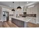Modern kitchen with white cabinetry, stainless steel appliances, a large island, and pendant lighting at 1142 Fiddlehead Way, Myrtle Beach, SC 29579