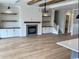 Inviting living room with fireplace, built-ins, hardwood floors, and views into the kitchen at 1142 Fiddlehead Way, Myrtle Beach, SC 29579