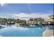 Community pool featuring a splashpad, lounge area, fountains, and well maintained landscaping at 1142 Fiddlehead Way, Myrtle Beach, SC 29579