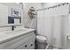 Bright bathroom with white vanity, quartz countertop, and a shower with white curtain at 1290 River Oaks Dr. # 7H, Myrtle Beach, SC 29579