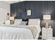 Bedroom with a navy accent wall, modern lighting, and stylish bedside tables at 1290 River Oaks Dr. # 7H, Myrtle Beach, SC 29579