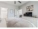 Open bedroom with a view into the kitchen, dresser with television, and daisy art hanging on the wall at 1290 River Oaks Dr. # 7H, Myrtle Beach, SC 29579