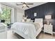 Comfortable bedroom featuring an accent wall, neutral color palette, and access to outdoor balcony at 1290 River Oaks Dr. # 7H, Myrtle Beach, SC 29579
