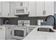 Bright kitchen with white cabinets, subway tile backsplash and stainless steel appliances at 1290 River Oaks Dr. # 7H, Myrtle Beach, SC 29579