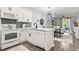 Open-concept kitchen featuring white cabinets, stainless steel appliances, and adjacent living area at 1290 River Oaks Dr. # 7H, Myrtle Beach, SC 29579