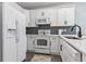 Clean kitchen with white cabinets, stainless steel appliances, and modern countertops at 1290 River Oaks Dr. # 7H, Myrtle Beach, SC 29579