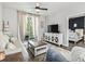 Bright living room featuring a cozy seating area and balcony access at 1290 River Oaks Dr. # 7H, Myrtle Beach, SC 29579