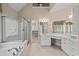Bright bathroom with double vanity, soaking tub, glass shower, and walk-in closet at 1315 Cherry Dr., Surfside Beach, SC 29575