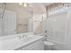 Bright bathroom with a white vanity, mirror, and shower/tub combo with white tile surround at 1315 Cherry Dr., Surfside Beach, SC 29575